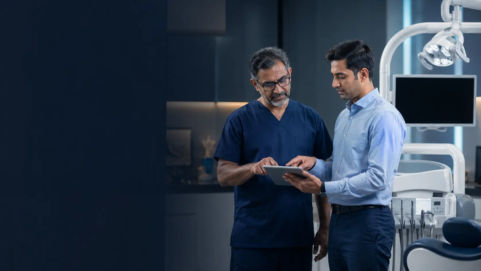 Clinician and technical support professional reviewing equipment information